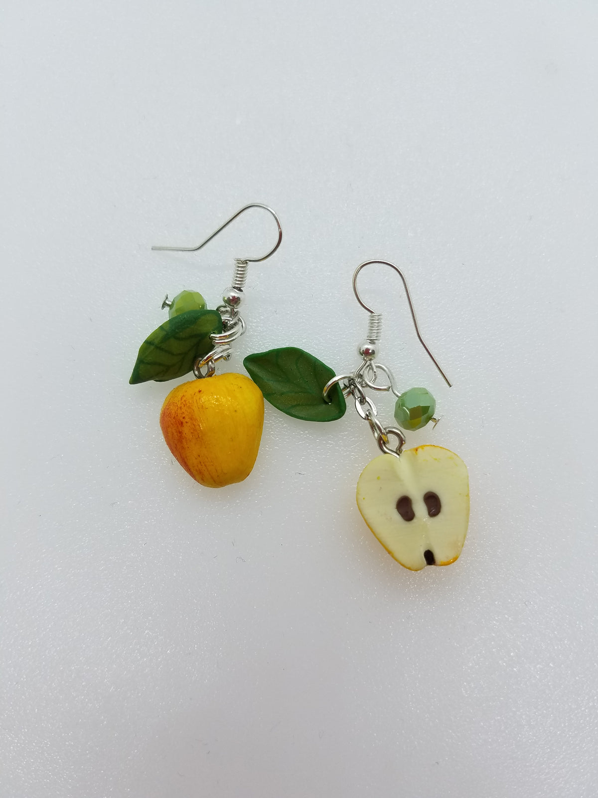 Polymer clay apple earrings with yellow-red whole apple and cut apple half charm, green leaves, asymmetric pair