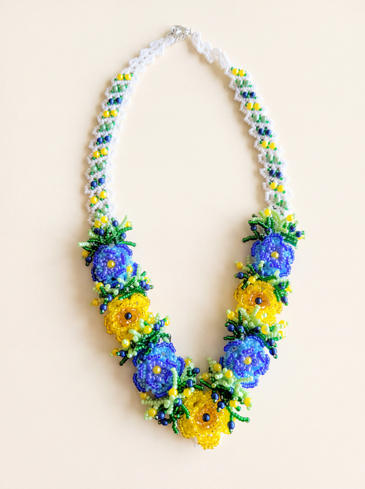 Handmade 3D flower beaded necklace with blue and yellow blossoms on a white daisy-chain strap, Ukrainian style