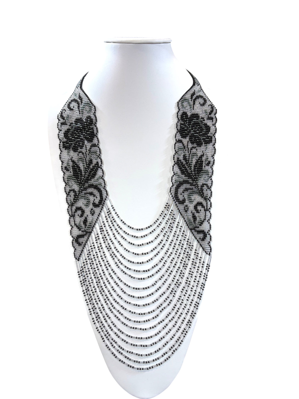 Black and silver beaded "Laces Flowers" necklace with floral panels and draped bead strands on a bust