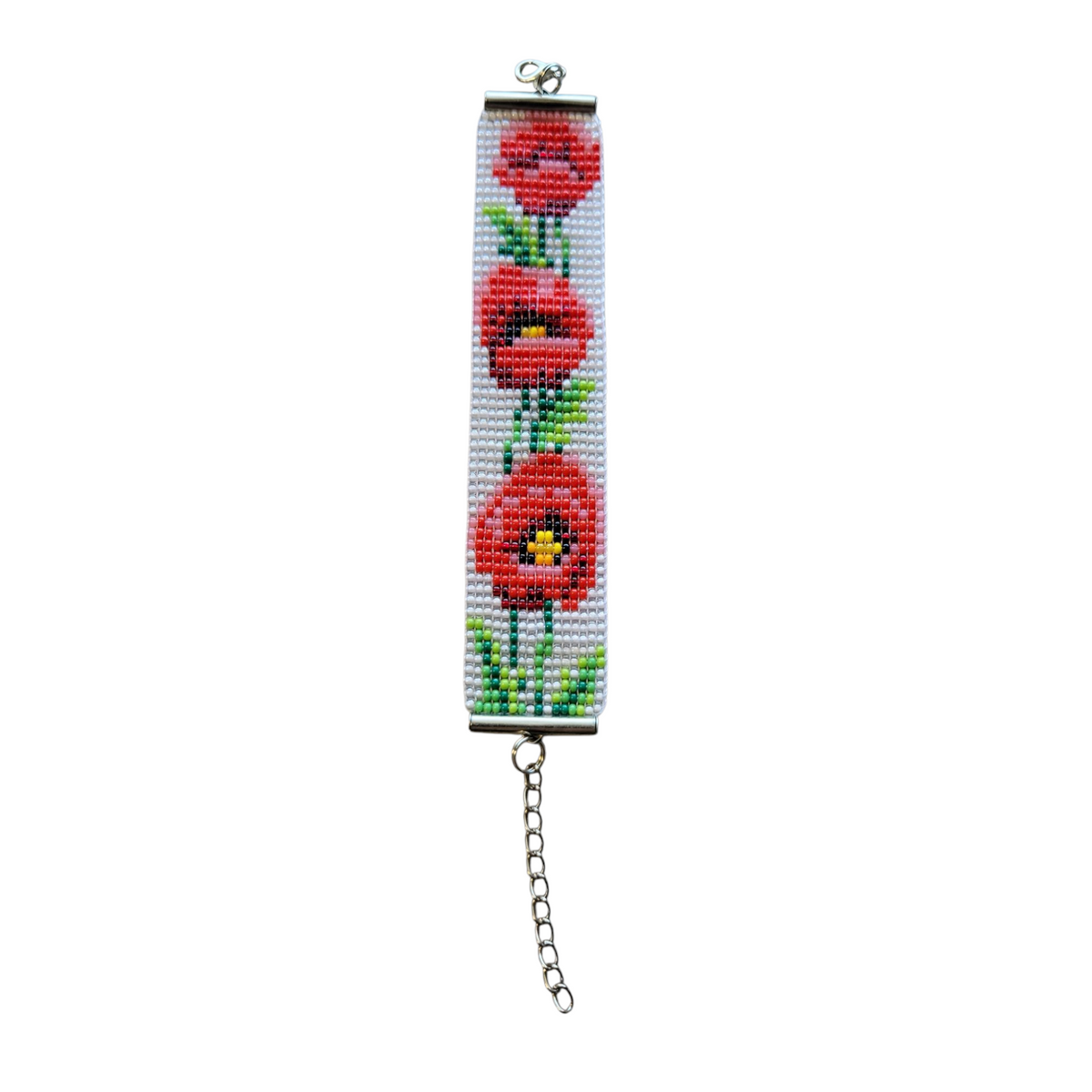 Loomed glass seed bead bracelet with three red poppies and green stems on a white ground, extender chain