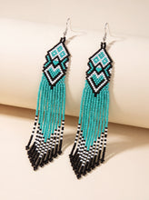 Handmade extra-long fringe earrings in turquoise, black and white glass beads with a small heart accent
