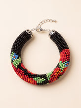 Handmade beaded bracelet "Poppies" with a black, red, green and blue seed bead floral pattern