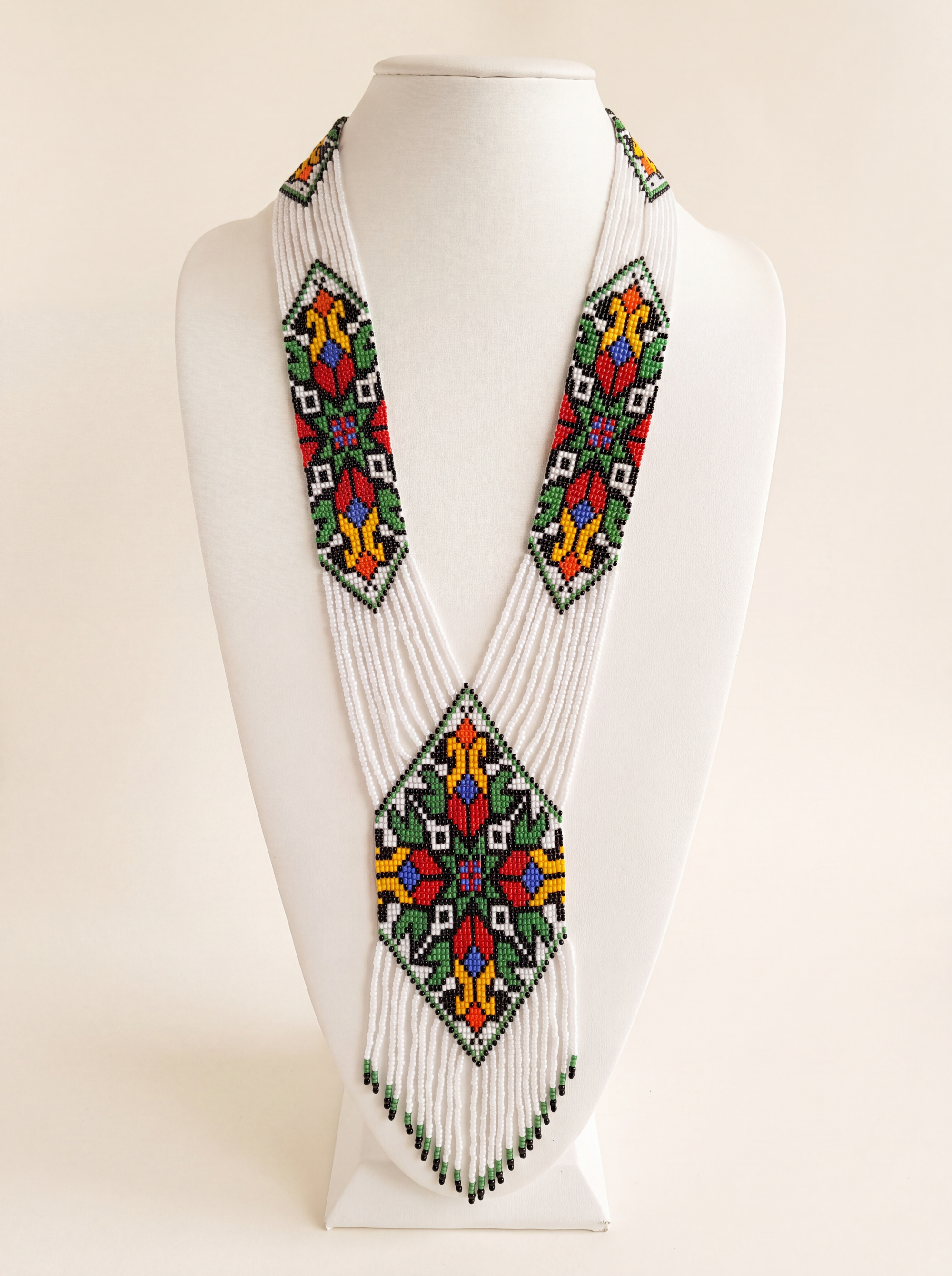 Handmade gerdan necklace of white glass seed beads with geometric folk tulip medallions in red, green and yellow