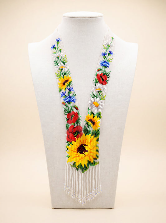Handmade beaded gerdan necklace with sunflowers, red poppies and cornflowers on a white background