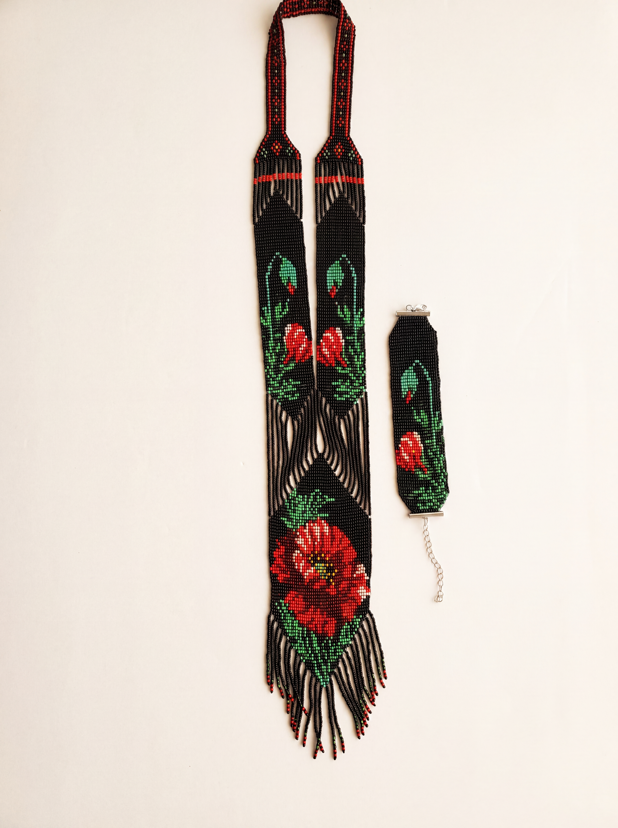 Handmade loomed gerdan necklace with red poppy motif on black glass seed beads, with matching bracelet
