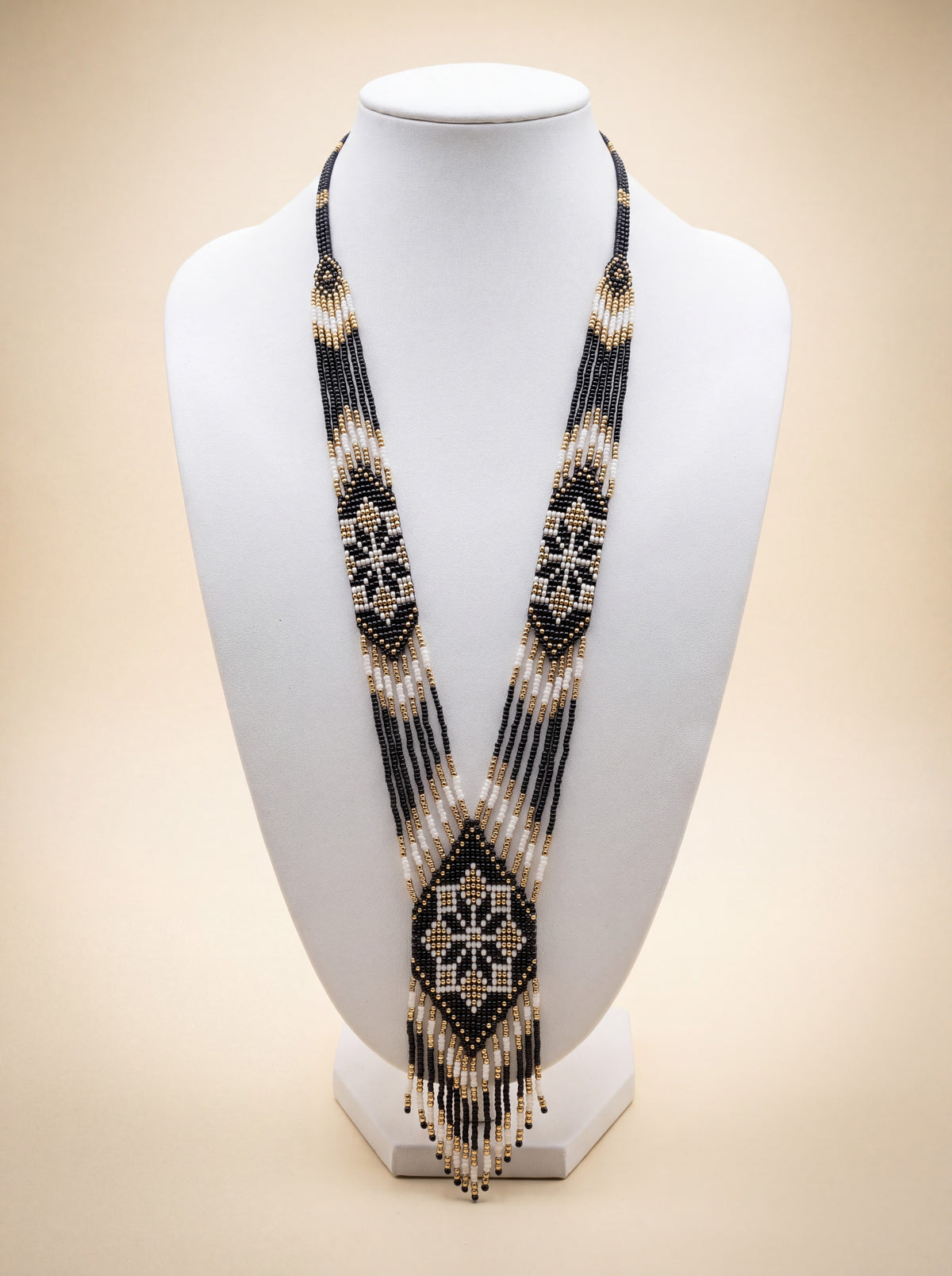 Handmade beaded gerdan necklace with black, white and gold diamond star pattern, long fringe