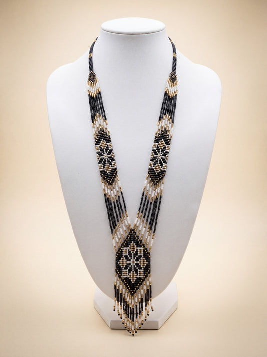 Handmade beaded gerdan necklace with black, white and gold diamond star pattern, long fringe