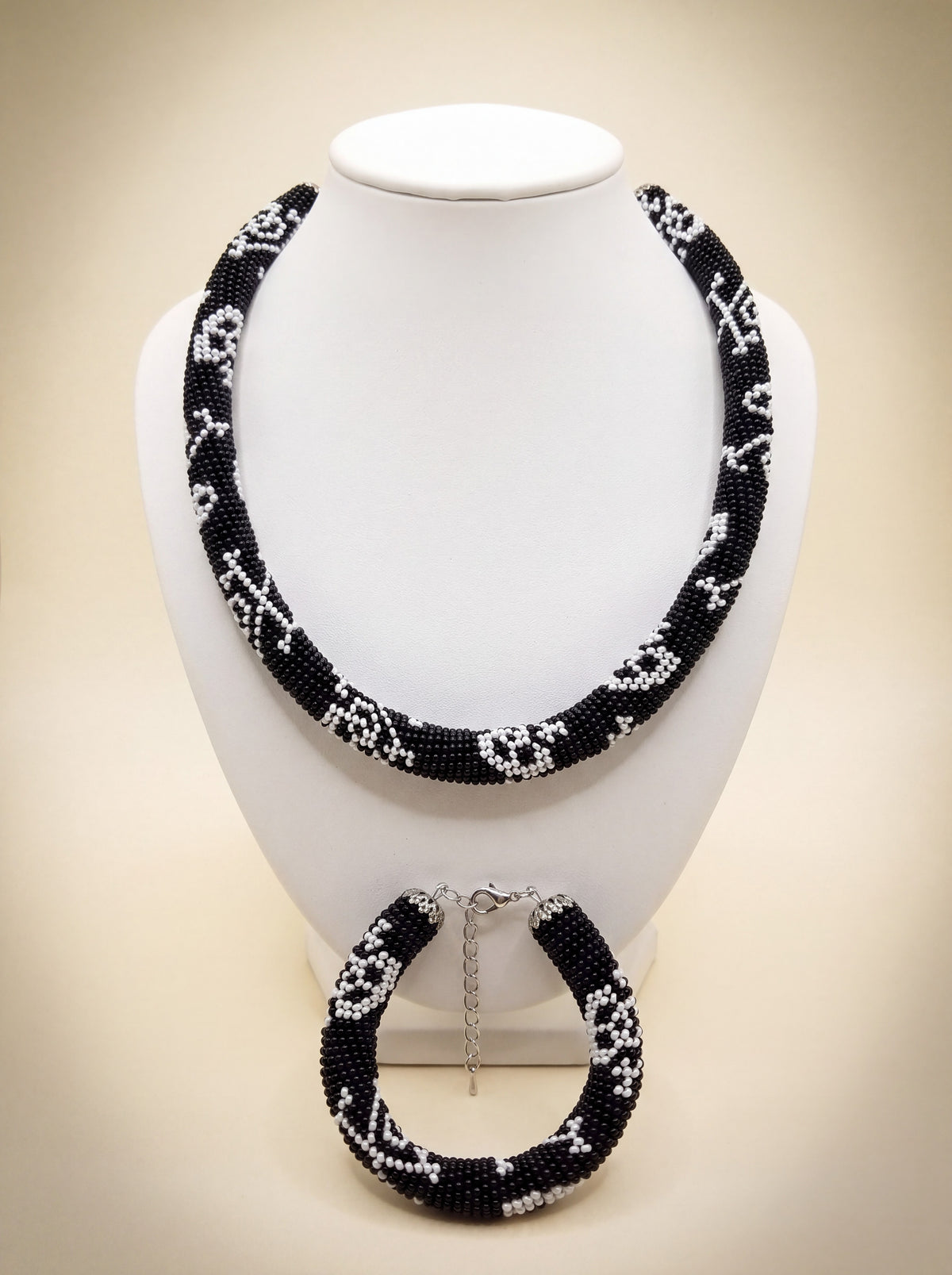 Handmade bead crochet necklace and bracelet set in black and white geometric skull pattern