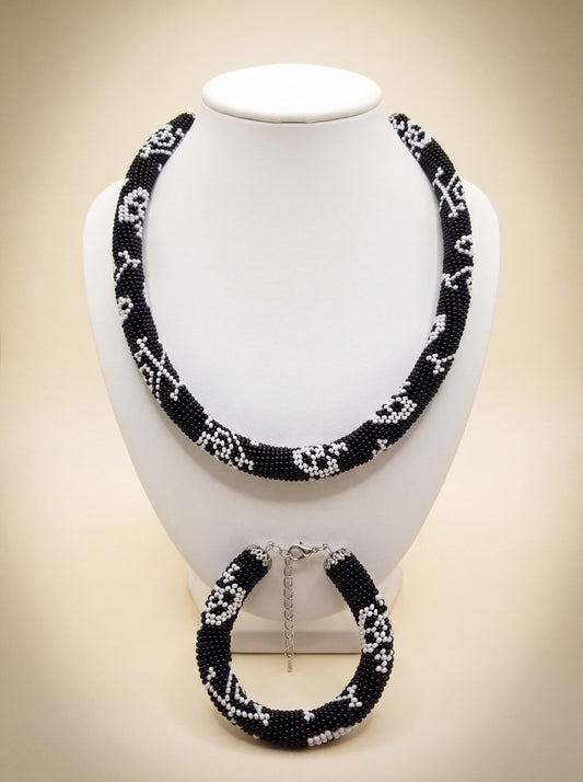 Handmade bead crochet necklace and bracelet set in black and white geometric skull pattern