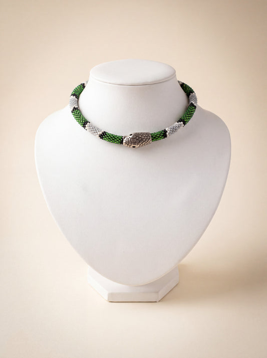 Handmade beaded snake choker with a green, white and black pattern and a silver snake head clasp