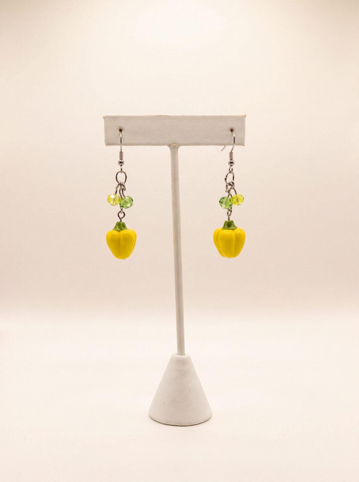 Handmade yellow bell pepper earrings with green crystal beads on silver hooks, playful food jewelry