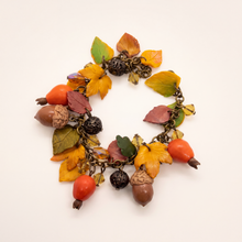 Handmade polymer clay charm bracelet with rose hips, acorns and autumn leaves in orange, gold and brown