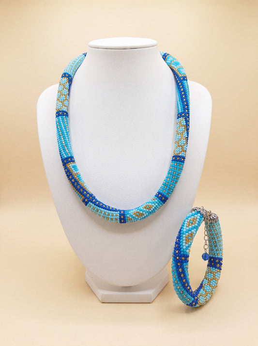 Handmade bead crochet necklace and bracelet set, turquoise and gold beaded rope with blue diamond pattern.