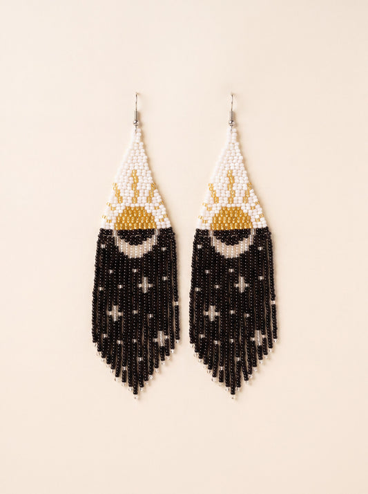 Extra long handmade beaded fringe earrings with gold sun on white and silver moon with stars on black night fringe, on cream
