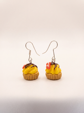 Cupcake earrings handmade from polymer clay with yellow frosting, chocolate drizzle and strawberry