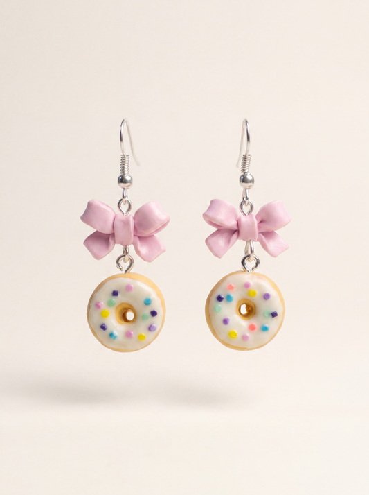 Donut earrings handmade from polymer clay, white glazed donuts with sprinkles and pink bows