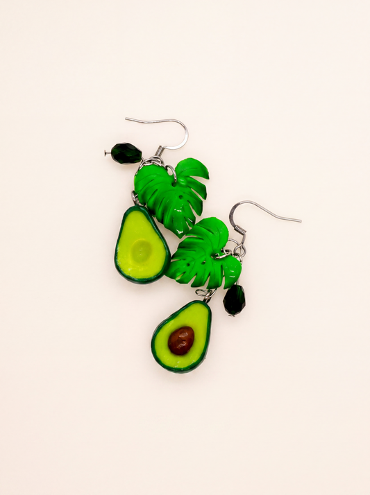 Avocado earrings handmade from polymer clay, halved avocados with monstera leaves and glass beads