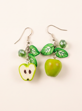 Green apple earrings handmade from polymer clay with leaves and crystal beads, one whole one halved