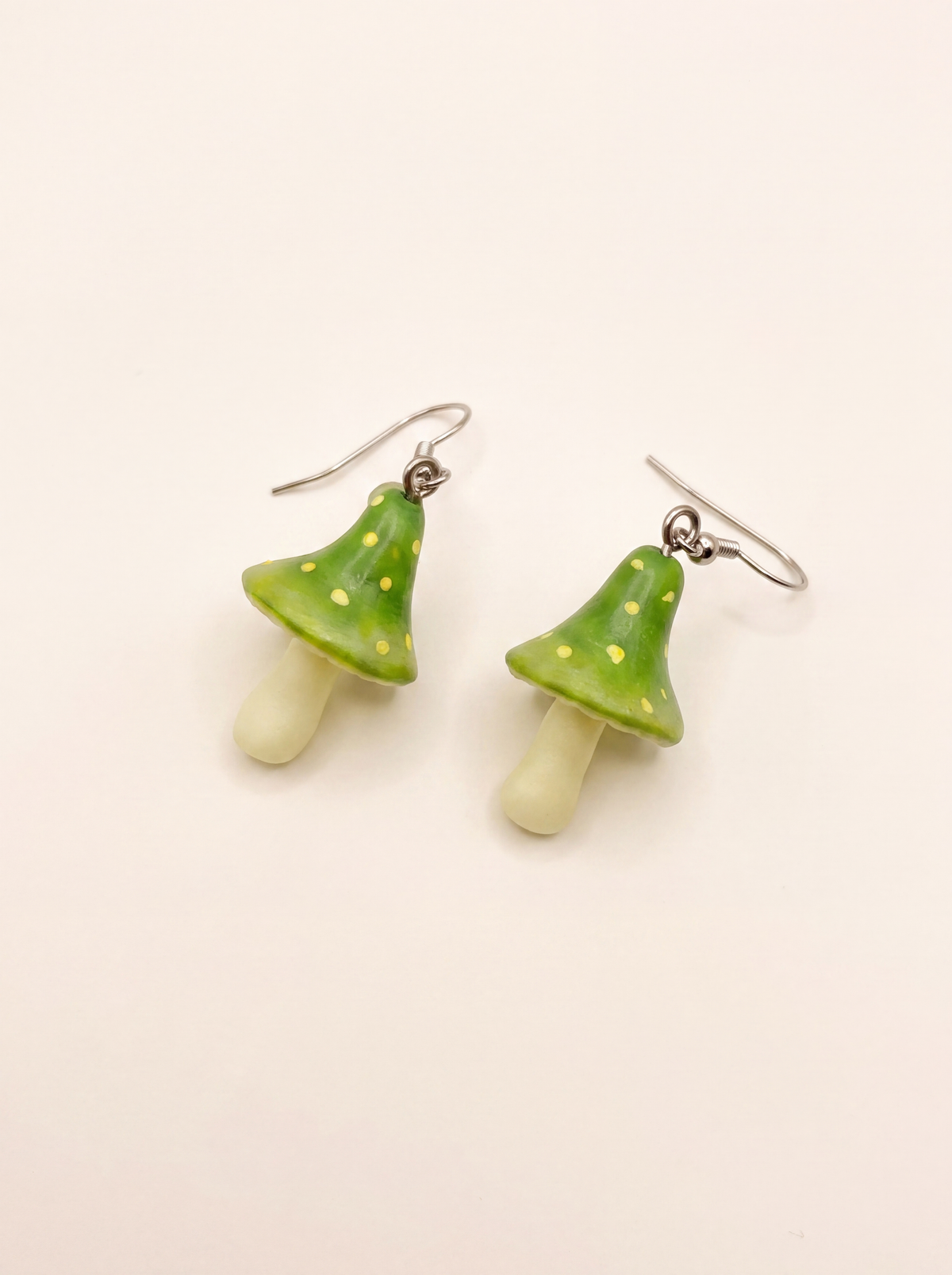Fairy mushroom earrings handmade from polymer clay, green dotted caps with cream stems