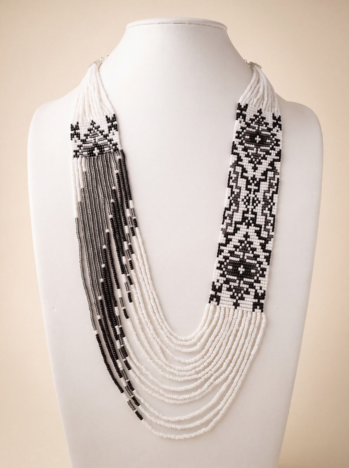 Handmade beaded "Asymmetry" necklace with black and white geometric panels and cascading fringe strands