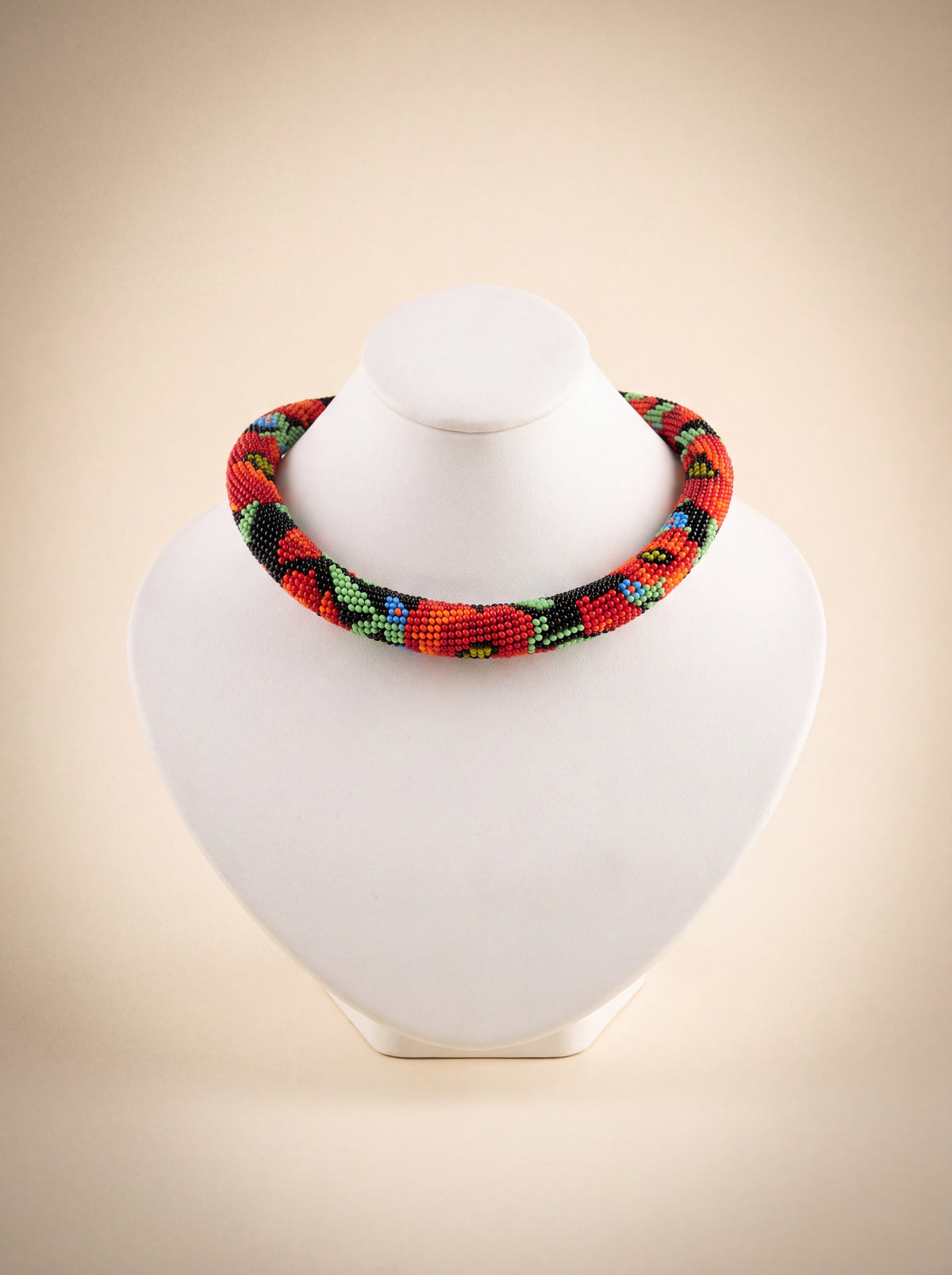 Handmade bead crochet choker with a red poppy pattern in green, black, and cornflower blue.