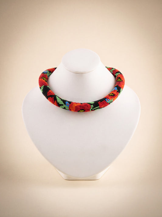 Handmade bead crochet choker with a red poppy pattern in green, black, and cornflower blue.