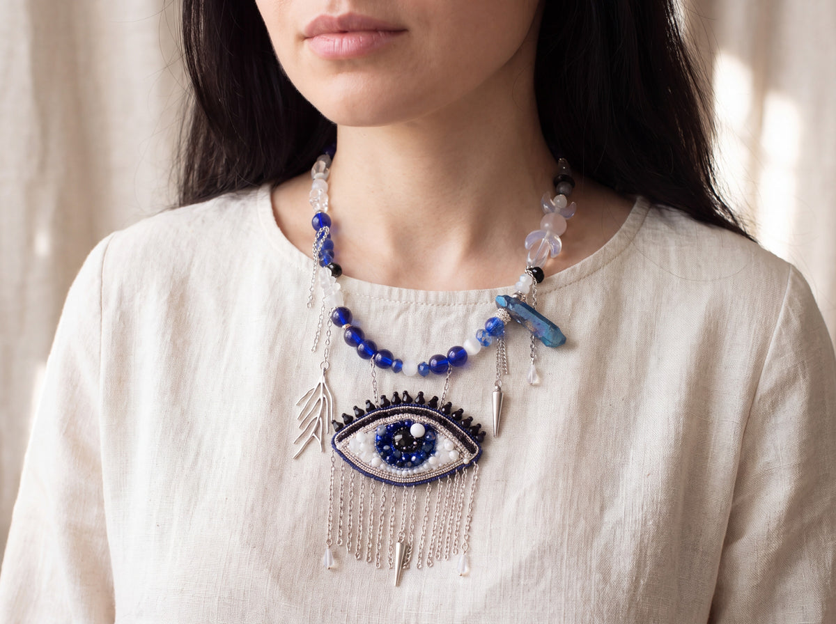 Evil eye beaded necklace worn, eye pendant with silver chain fringe on the chest