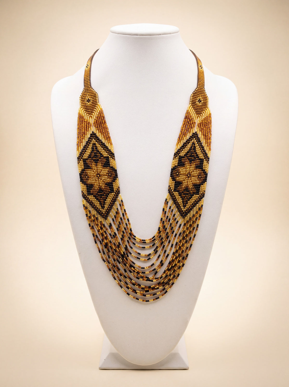 Handmade beaded bib necklace "Marichka" with loomed amber and black diamond lozenge pattern and fringe strands.