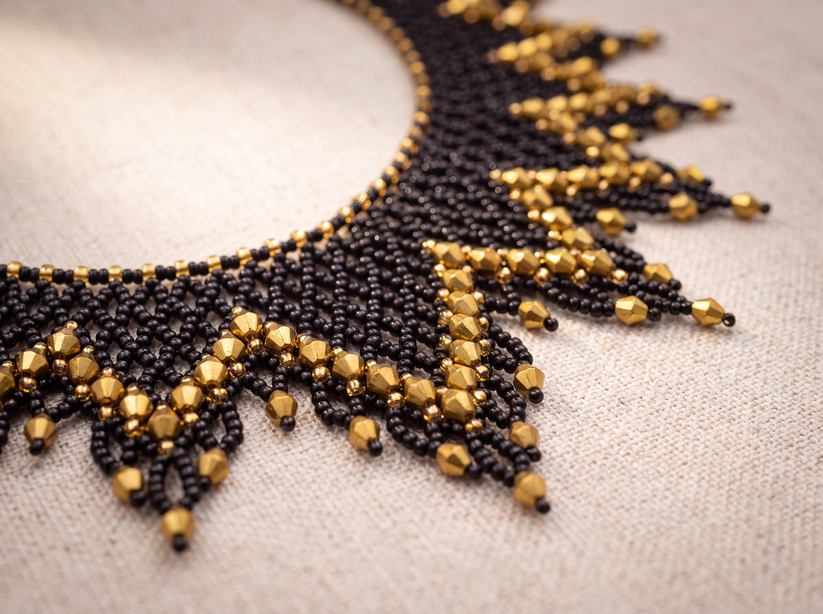 Macro detail of black beaded rays edged with gold faceted crystals
