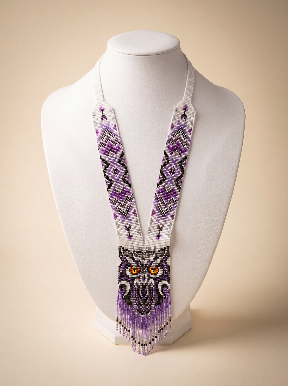 Handmade owl necklace, loomed glass seed beads in purple and white geometric pattern with fringe.