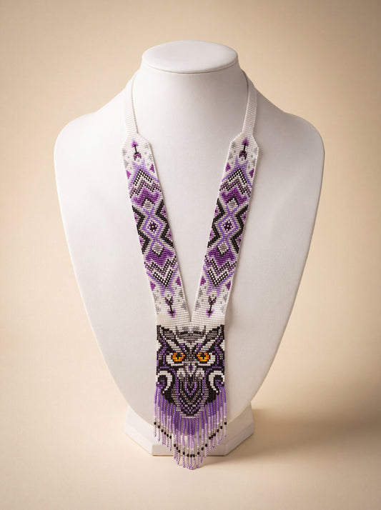 Handmade owl necklace, loomed glass seed beads in purple and white geometric pattern with fringe.