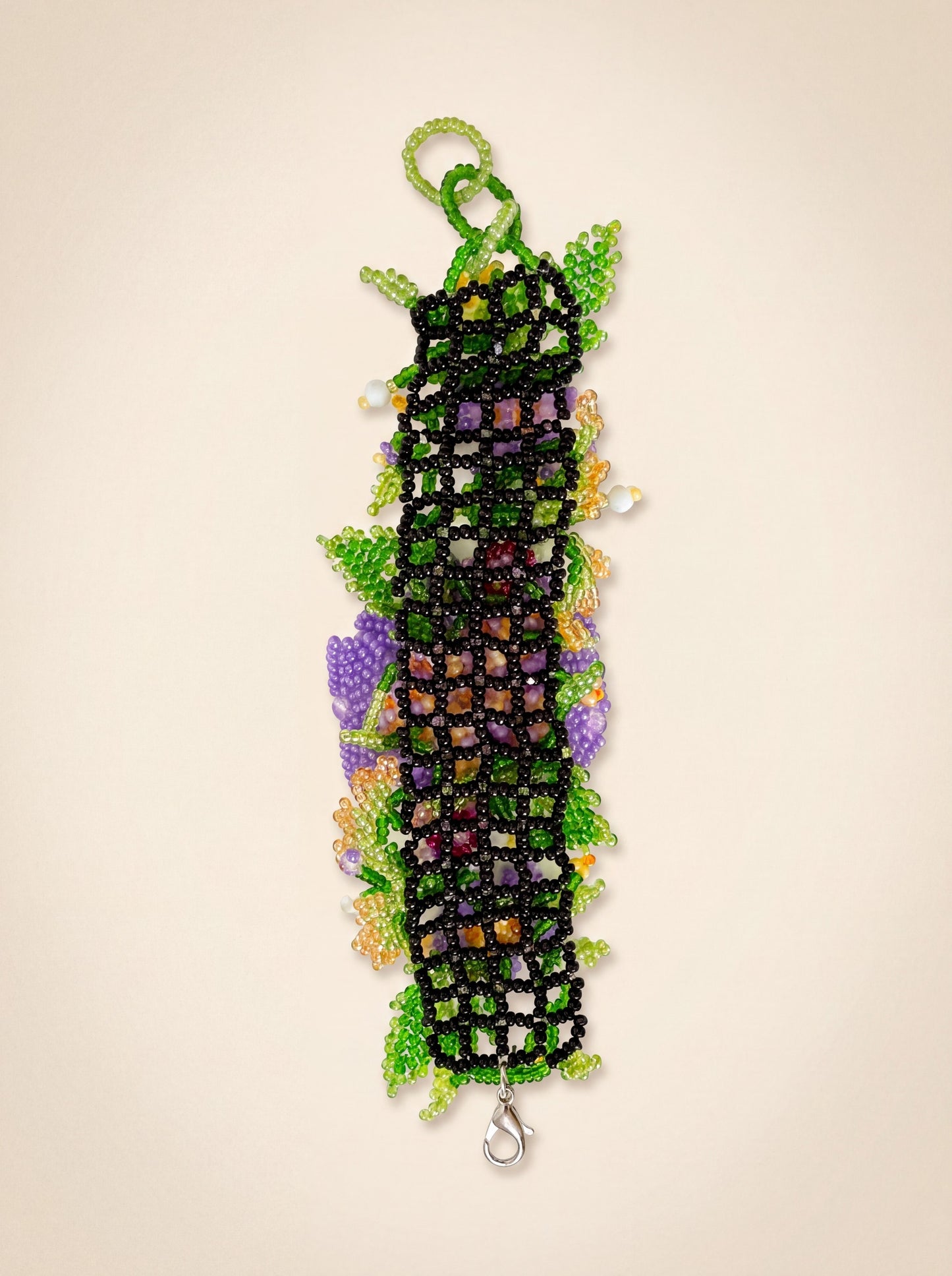 Back of the "Violets" bracelet showing the black beaded net base, loop and clasp