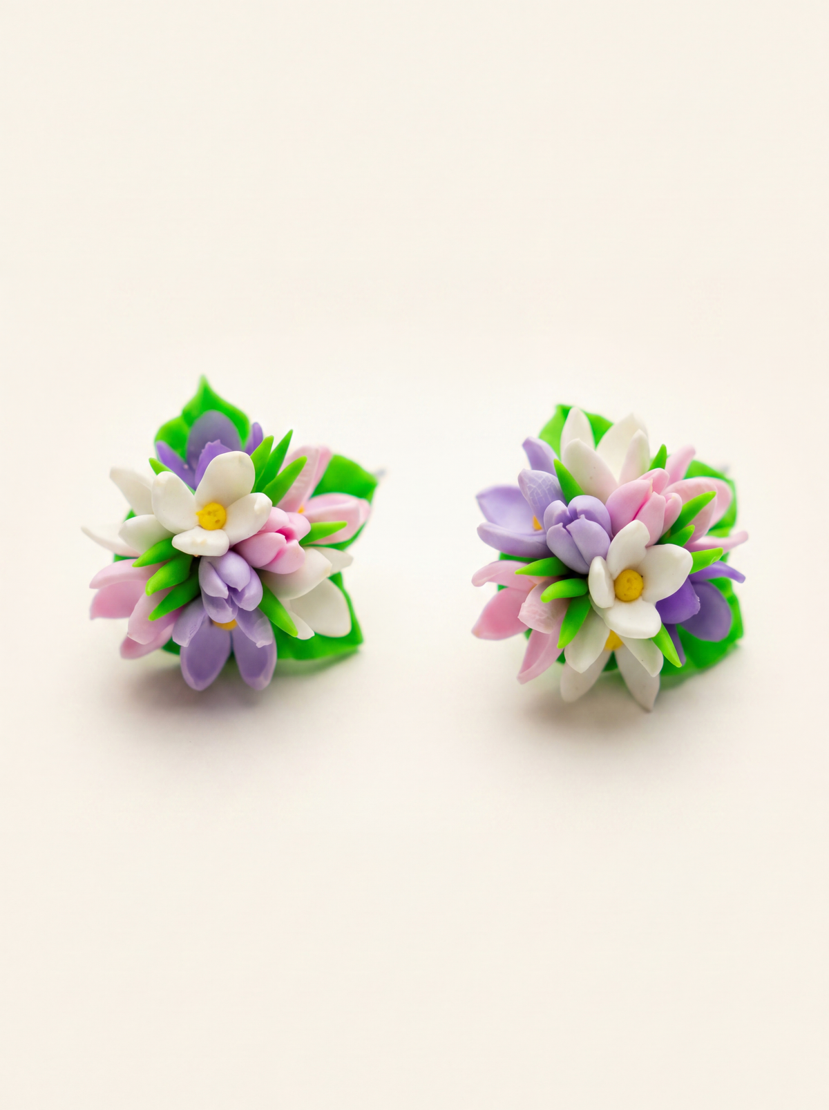 Spring flower stud earrings handmade from polymer clay with pink, purple and white blossoms