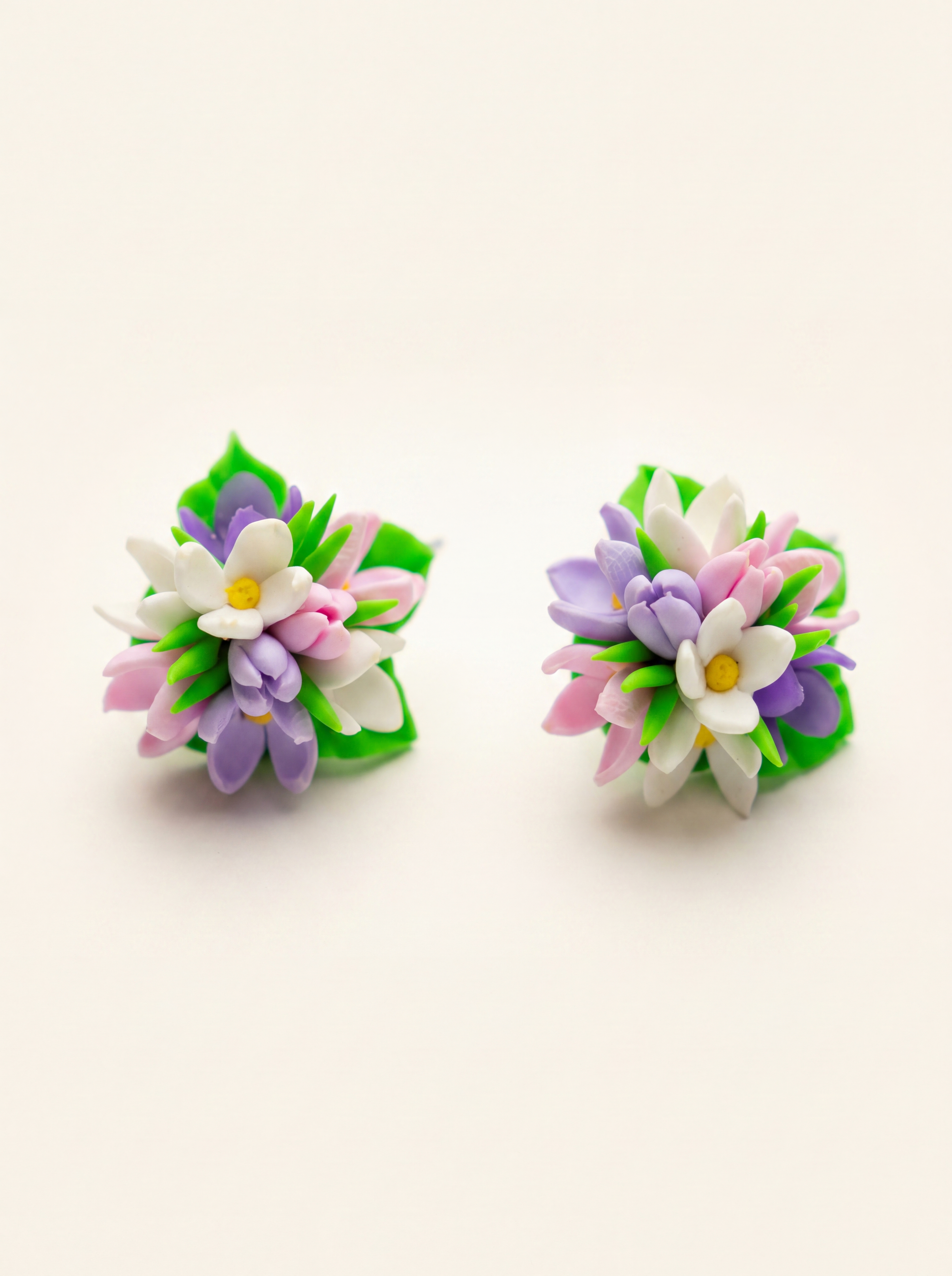 Spring flower stud earrings handmade from polymer clay with pink, purple and white blossoms