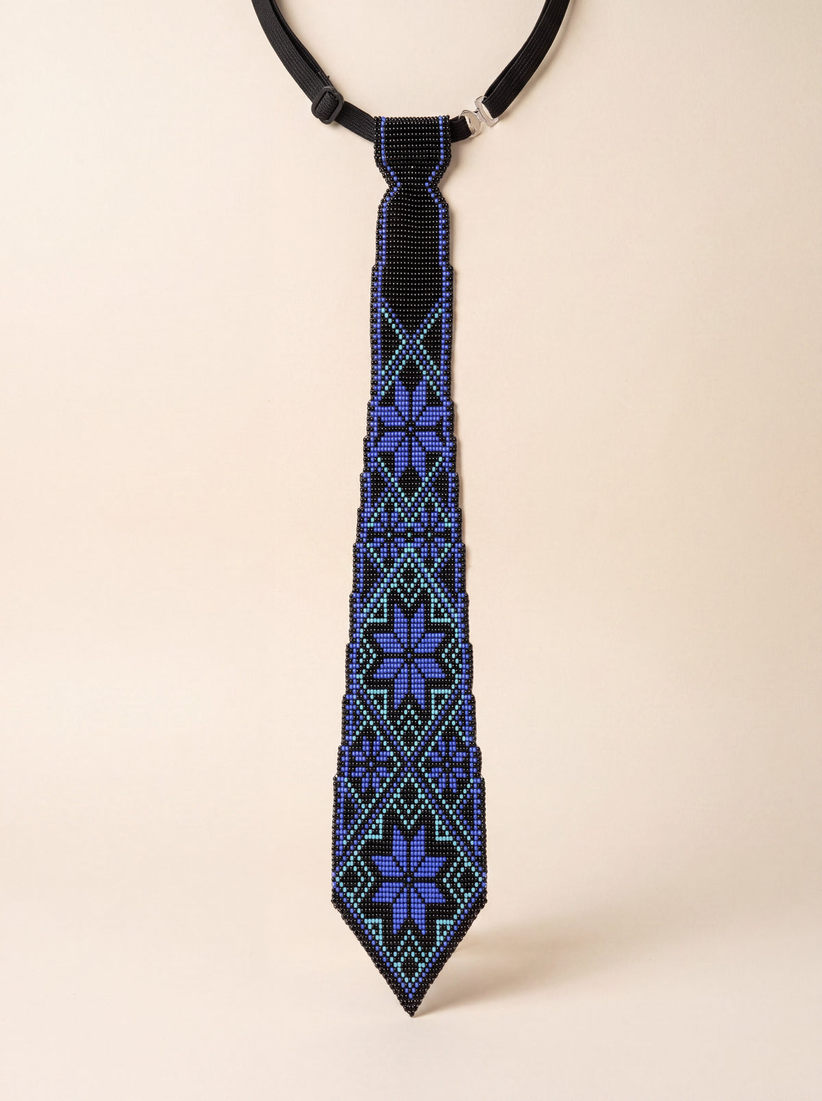 Handmade beaded tie, black with blue and turquoise geometric Ukrainian ornament pattern.