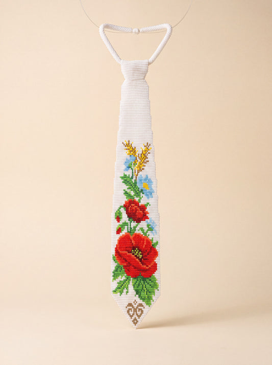 Handmade white beaded tie-necklace, "Poppy" design, with red poppy flowers, blue blossoms and green leaves.