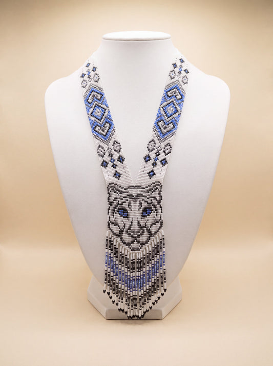 Handmade beaded gerdan necklace with a tiger face motif in white, blue, gray and black glass seed beads, fringe trim.
