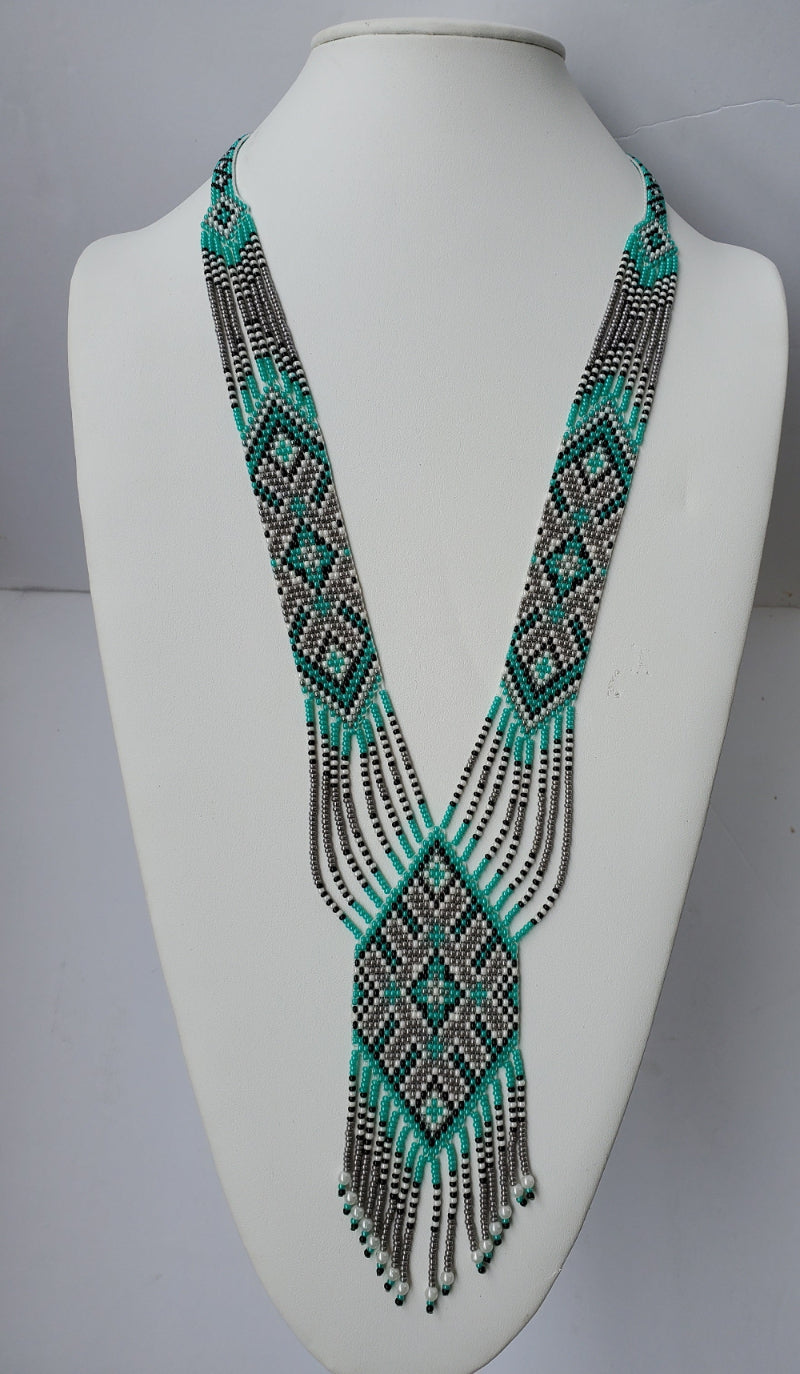 Turquoise and gray beaded gerdan necklace with pearl-tipped fringe shown on a white display bust