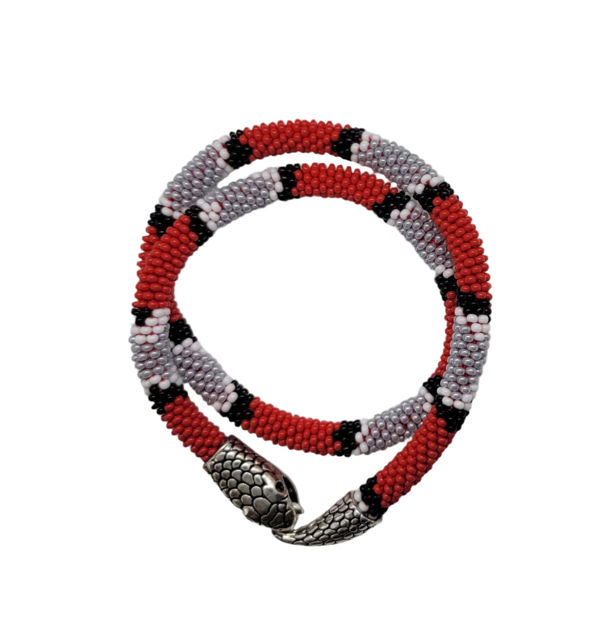 Red, gray and black coral-snake patterned beaded choker coiled in a circle, silver head clasp, top view
