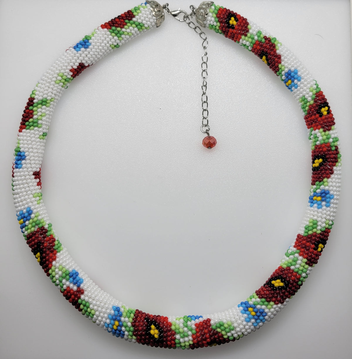 White Poppies beaded choker coiled with a red crystal drop on the extender chain, seed bead crochet