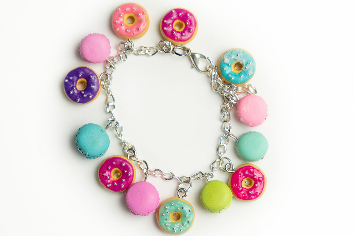 Donuts and macarons polymer clay bracelet from above, showing lobster clasp and colorful sweet charms