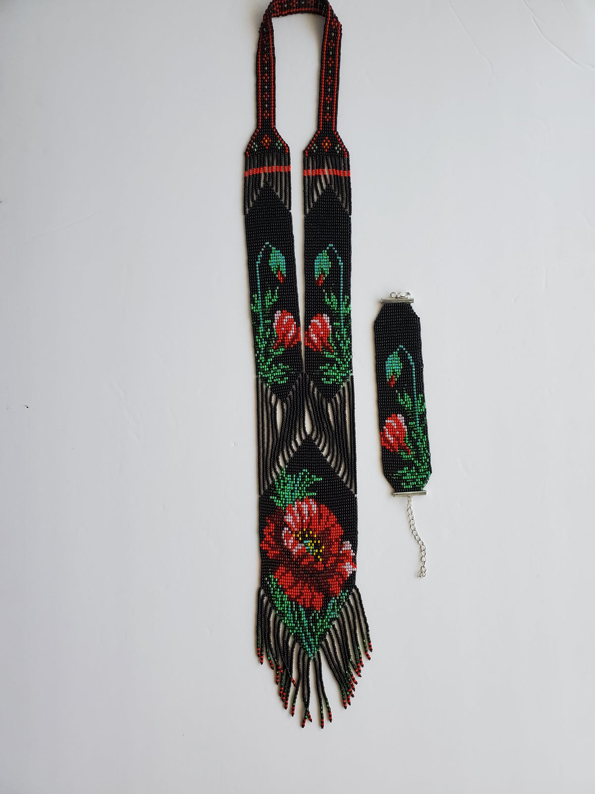 Black colorway of the poppy gerdan necklace with matching loomed beaded bracelet on white
