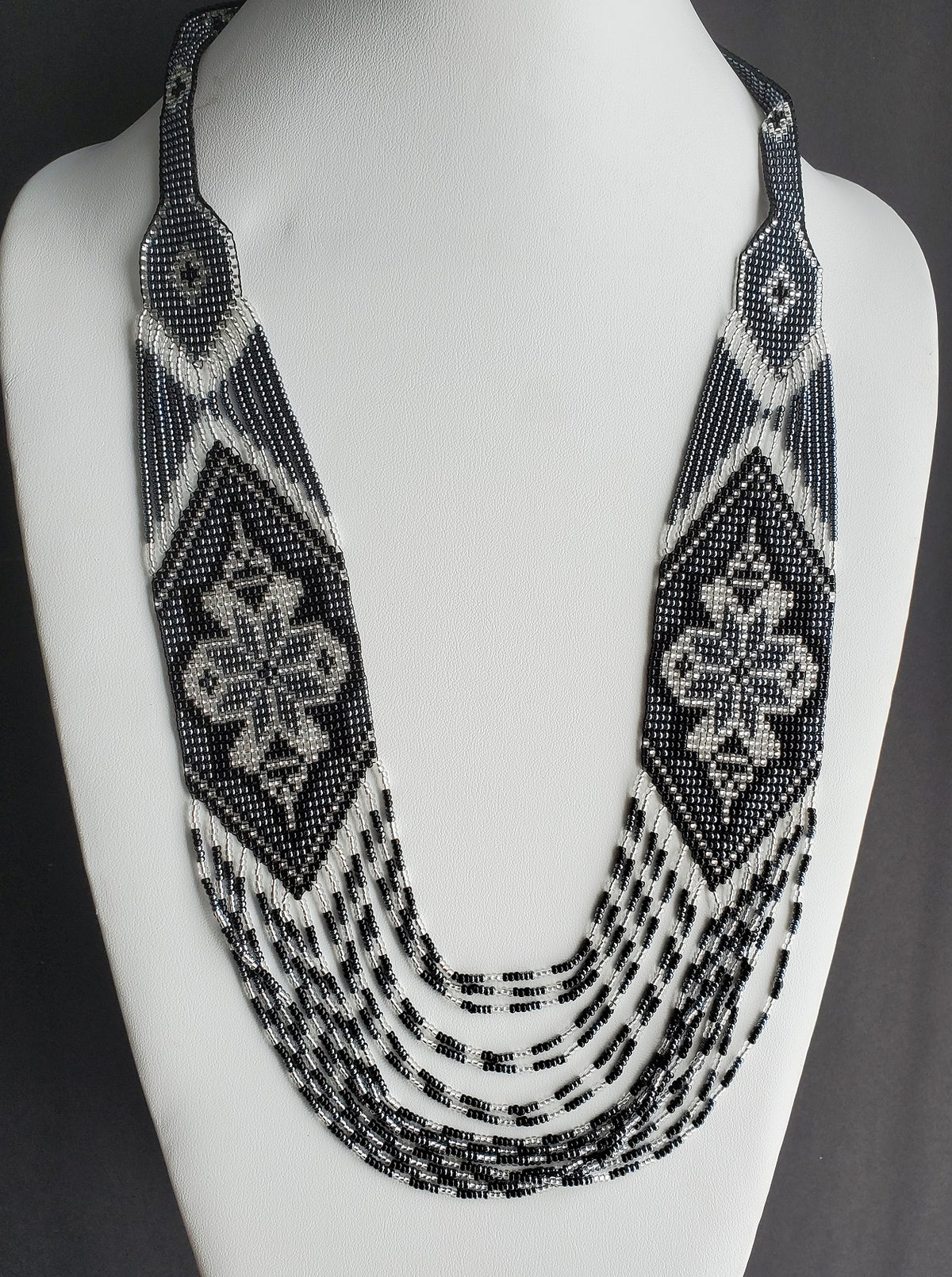 Handmade "Marichka" bead crochet rope necklace in glossy black with silver diamond accents on a bust