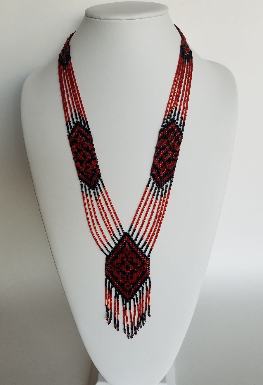 Beaded gerdan necklace "Gerdan S" in red and black Ukrainian folk pattern displayed on a white bust