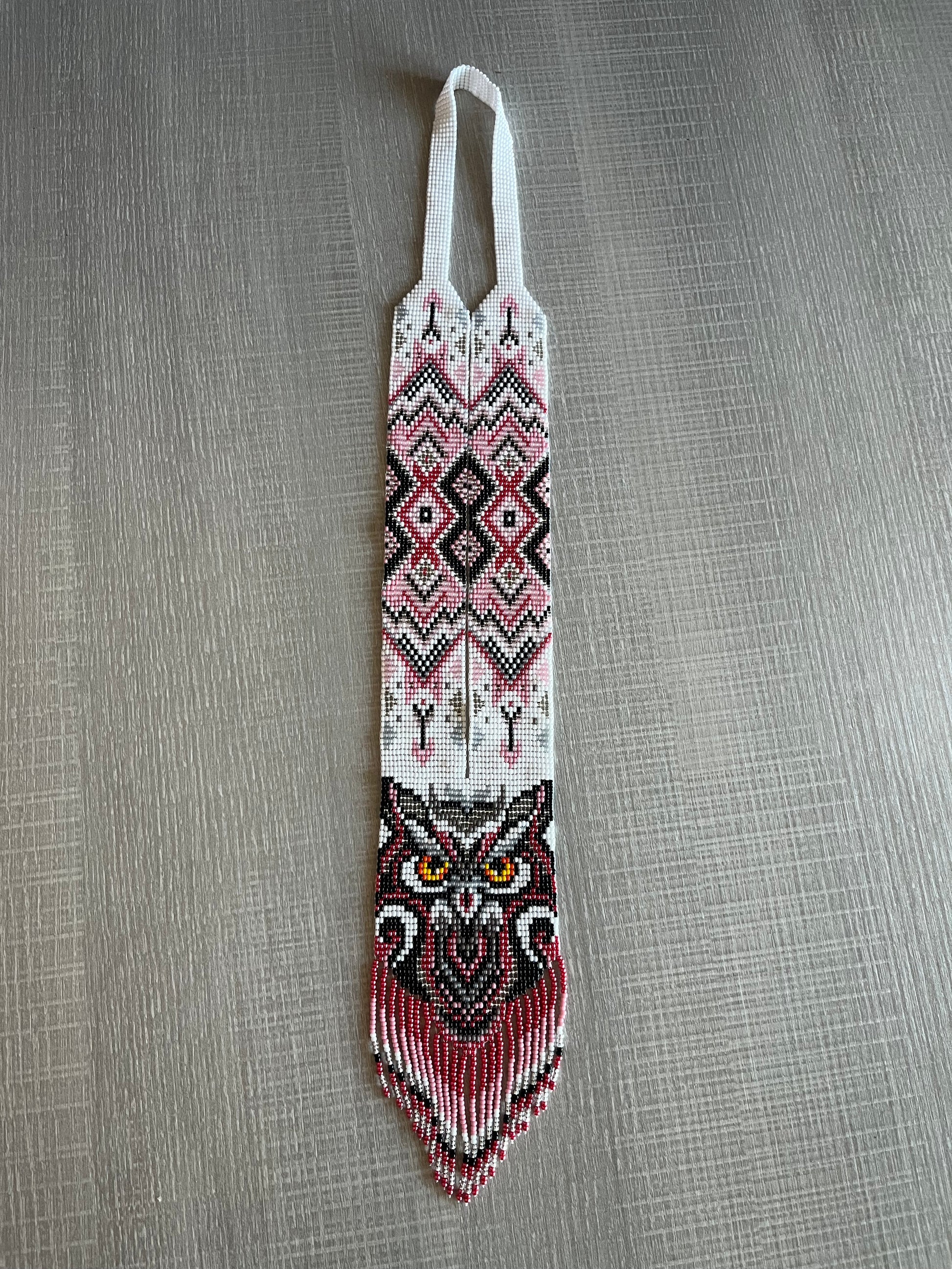 Handmade owl gerdan necklace in pink and burgundy seed beads with fringe, flat lay